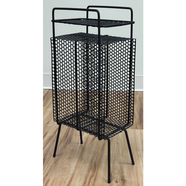 Vintage black perforated metal mesh stand in the style of Richard Galef's Ravenware telephone stand. Iconic metal table...