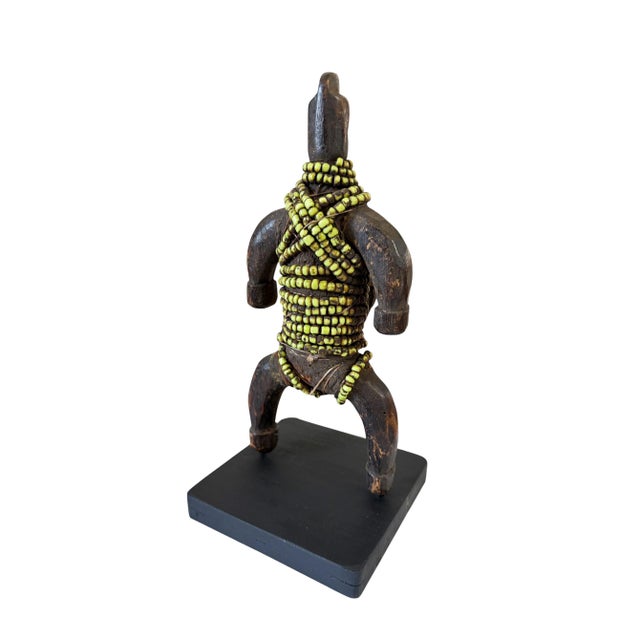 This stunning African fertility doll is adorned with multiple layers of intricate glass beads and a leather amulet....