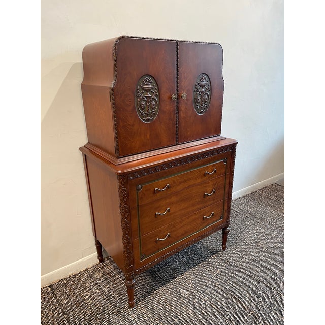 This elegant 1930s cabinet combines generous storage with the refined ornamentation typical of the period. Its warm,...