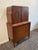 This elegant 1930s cabinet combines generous storage with the refined ornamentation typical of the period. Its warm,...