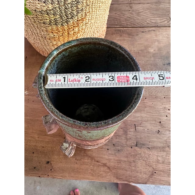 A one-of-a-kind handcrafted studio pottery vessel featuring a richly textured surface, incised geometric patterns, and...