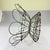 From France, a hand-made Fil de Fer, iron wire egg basket, circa 1890 – 1910. A round, petal top footed, folding basket...