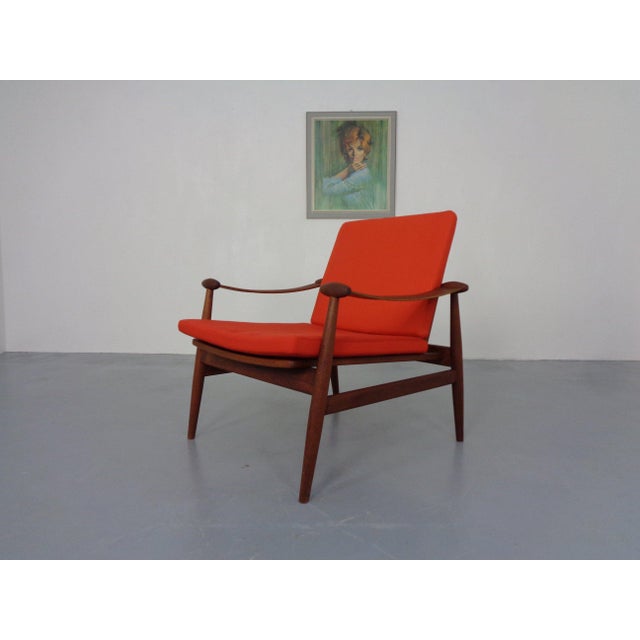 Model 133 teak armchair by Finn Juhl for France & Søn from the 1960s. Both cushions have zippers. This piece has an...