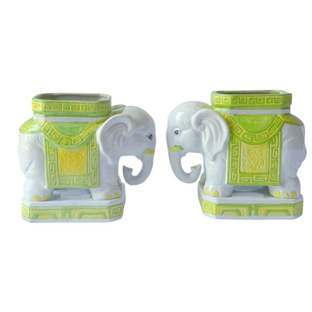 This is a whimsical pair of vintage ceramic elephant planters, decorated in soft white, lime green, and yellow with raised...