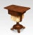 Rosewood sewing table, the well-figured top with lift-up ends above two frieze drawers with knob hands to the upholstered...