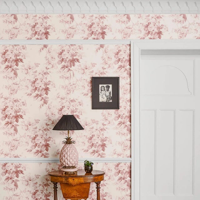 The 'London Rose' wallpaper features a classical hand-painted English rose design in a Blush against an off-white base....