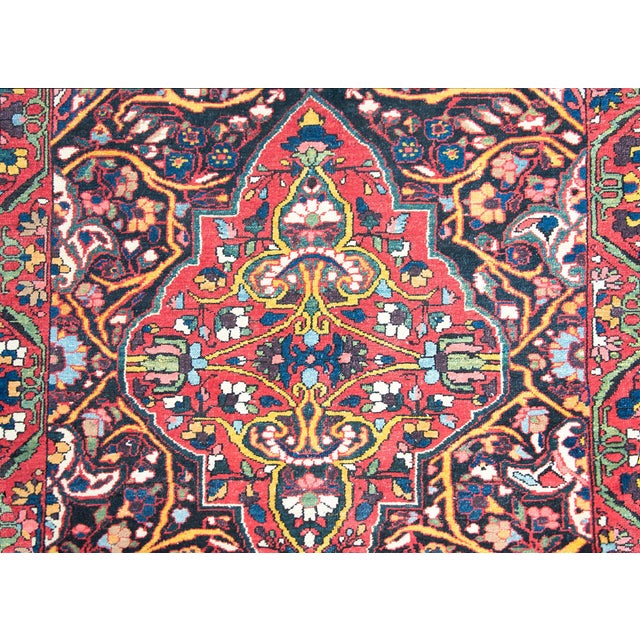 An wonderful early 20th century Persian Bakhtiari rug with two large medallions composed of myriad scrolling vines and...
