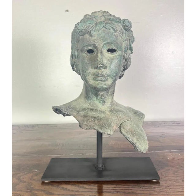 19th century French bronze head of a boy mounted on an iron base. It is a great accent for a side table or bookshelf.