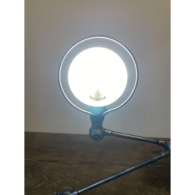 Authentic vintage Jieldé lamp with a clamp-style mount, consisting of a 40cm arm and a 25cm arm. The lamp has been...