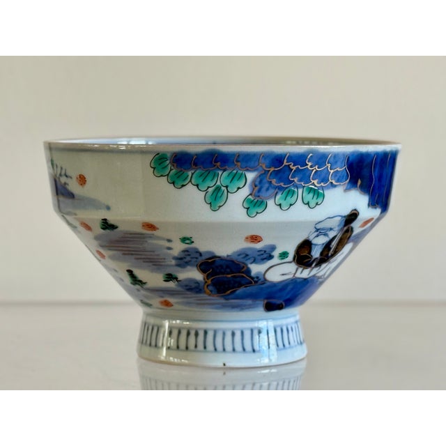 An Imari porcelain bowl on raised foot. One side decorated with calligraphy. Japanese early 20th century.