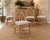 A beautiful set of four vintage Cathedral dining chairs by McGuire of San Francisco. Crafted from rattan with McGuire’s...