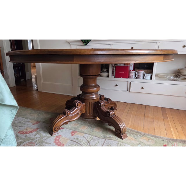 Beautiful large solid round antique table; easily accommodates 7 dining chairs. 62 inch diameter; 30.5 inches tall. Age is...