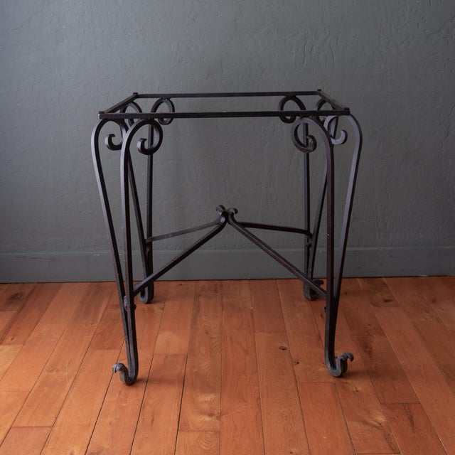 This French Art Deco outdoor black wrought iron table base features scrolling legs with particularly expressive upturned...