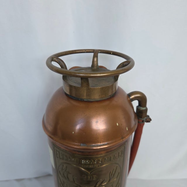 This substantial antique Elkhart Brass Manufacturing Co. 2½-gallon soda-acid fire extinguisher retains much of its...