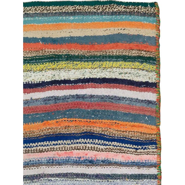 A vintage Persian flat-woven Kilim rug from the mid-20th century. A Kilim is a flat tapestry-woven carpet or rug...