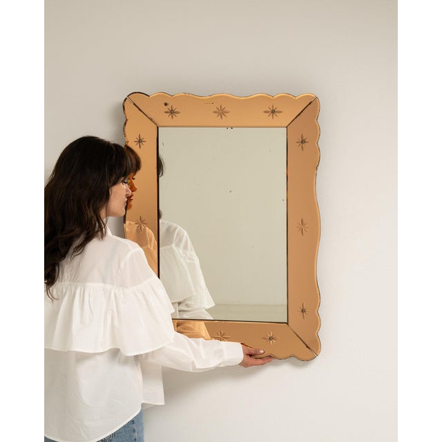 This mirror makes its impression through tan/champagne scalloped frame with star accents. The piece dates to 1940s,...