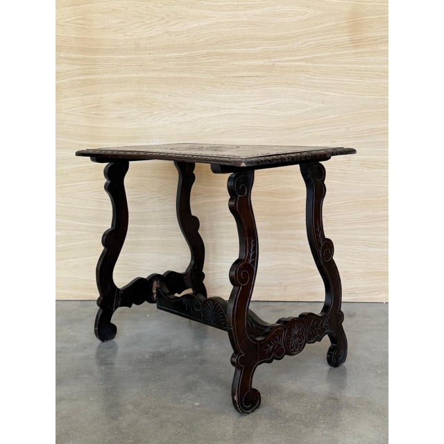 19th century Spanish trestle table in walnut. This piece has a great scale, lovely carved lyre legs and beautiful ebonized...