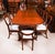 This is an elegant vintage dining set that comprises a Regency Revival triple pillar dining table, dating from the mid...