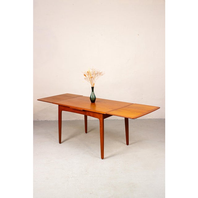 A beautiful Danish teak dining table designed by Svend Aage Madsen. The rounded corners and softly shaped edges give the...
