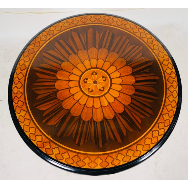 An exceptional John Widdicomb round occasional table featuring a masterfully executed compass star marquetry top, rendered...