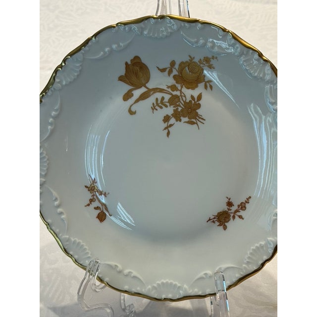 This plate is extensively decorated with hand painted roses in gold and gold painted scalloped border.