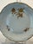 This plate is extensively decorated with hand painted roses in gold and gold painted scalloped border.