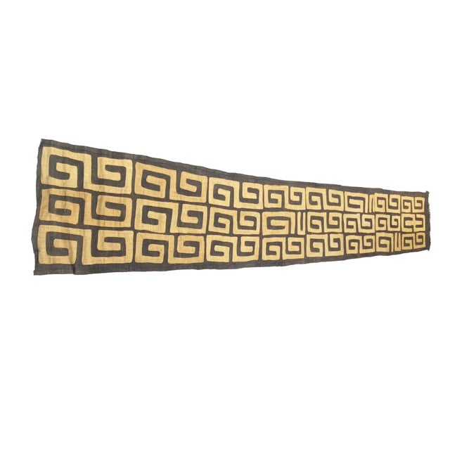 This Kuba-made raffia textile features a combination of two techniques: appliqué and tie-dye, making it a unique wall...