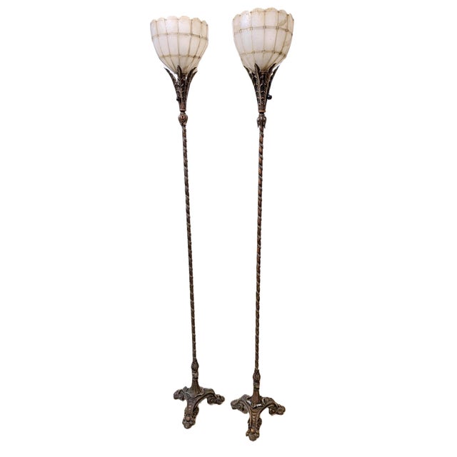 A striking pair of antique Art Nouveau torchiere floor lamps featuring beautifully sculpted cast metal bases with twisted...