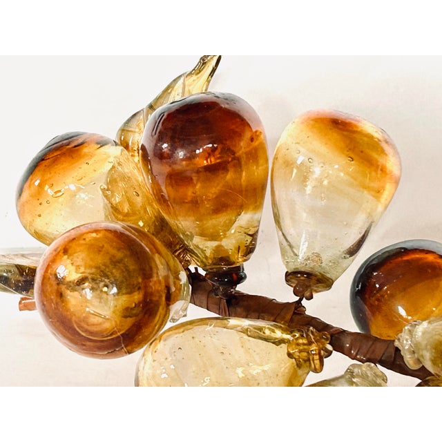 A set of three hollow blown glass grape clusters, in gorgeous hues of amber, yellow and brown. The set includes one long...