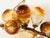 A set of three hollow blown glass grape clusters, in gorgeous hues of amber, yellow and brown. The set includes one long...