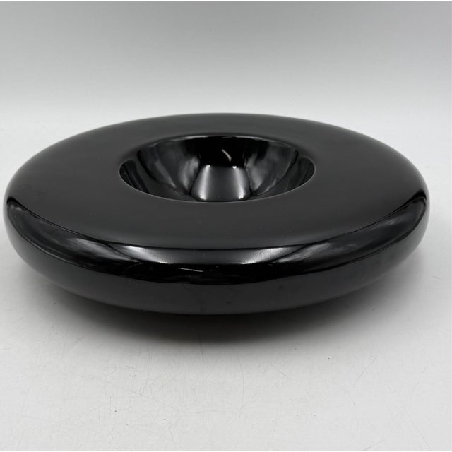 Circa 1960s–1970s, Italy. A sculptural low bowl in glossy black glazed ceramic, of rounded, biomorphic "space age" form...