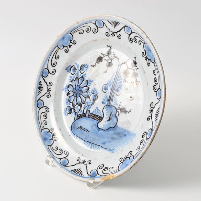 Hand-painted Delftware dish / plate. Decorated with cobalt and manganese paints. Made in the 18th century.