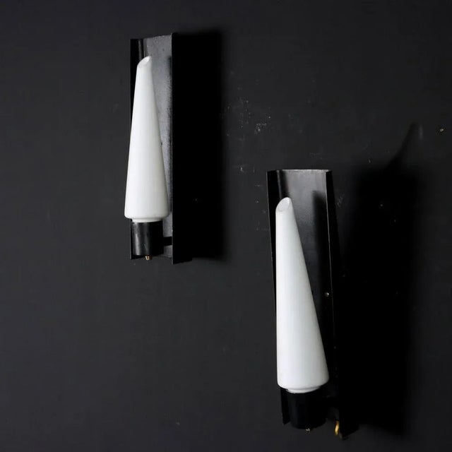 Pair of wall lamps in enameled metal with opaline glass diffuser. This piece is attributed to the mentioned...