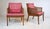 Stunning pair of Mid Century Modern swag caned arm lounge chairs by Erwin Lambeth, designed and manufactured by John...