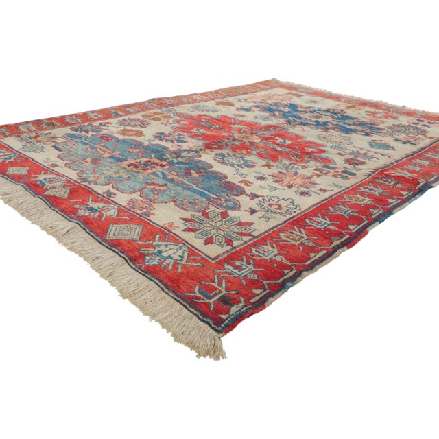 Warm and inviting with rustic sensibility, this hand-knotted wool vintage Turkish rug is a captivating vision of woven...