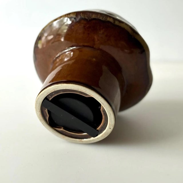 Mid century brown and white mushroom with holes that is meant to allow light through from a tea light or votive. Still has...