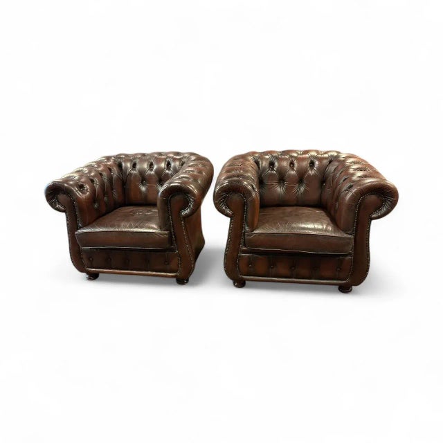 Traditional Chesterfield armchairs with genuine leather, deep button tufting rolled arms and studded detailing. Beautiful...