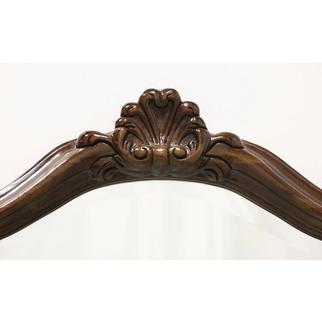 An Italian Provincial style wall mirror by Century Furniture, from their Cardella Collection. Beveled mirrored glass in a...