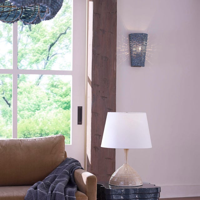 The simple, tapered lines of this wall sconce are beautifully accented by hand-carved blue mango wood beads, each one...