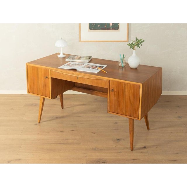 1950s Mid-Century Desk very good craftsmanshiphigh-quality materialssolid wood drawersMade in Germany Table Underside:...