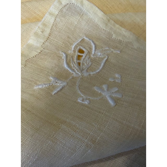 Exquisite antique set of twelve French linen hand embroidered dinner napkins.