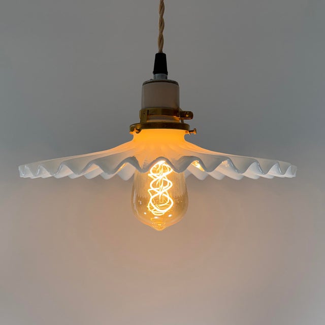 A beautifully hand-blown white opaline glass pendant light dating to the 1930s. This classic “frill,” “pie crust,” or...
