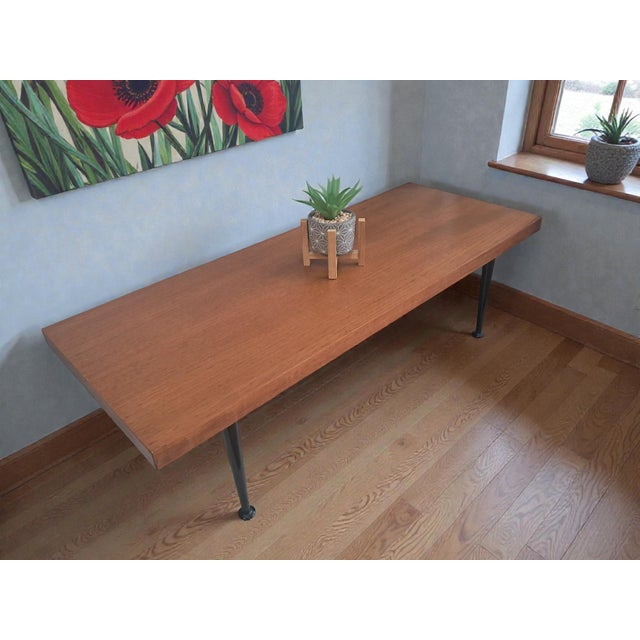 This is a Retro Vintage 1960's very stylish Mid Century Modern coffee table. The teak table top sits on black dansette...