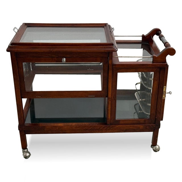 Elegant serving trolley dating from the 1930s. This exceptional piece combines practical functionality with refined...