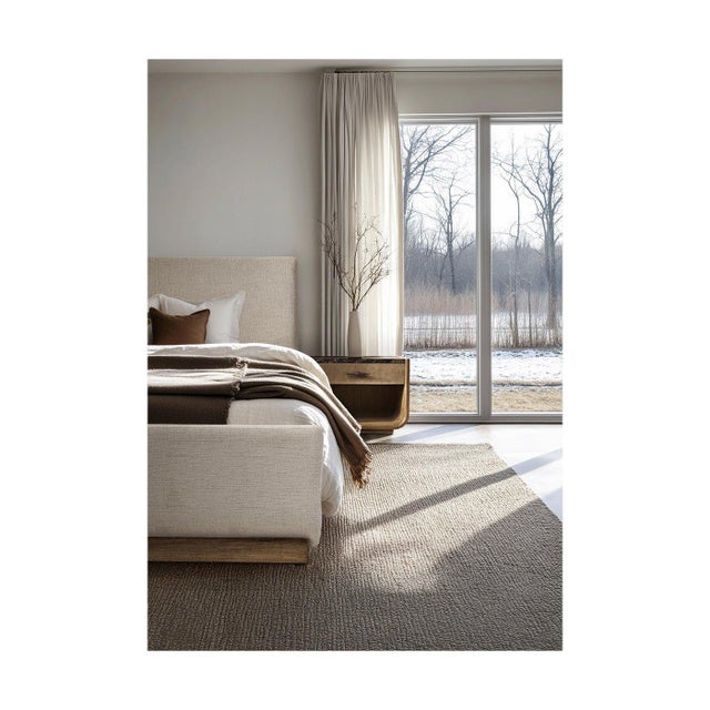 The Queen Bed with a wood base has a calm, modern look with clean lines, a softly padded headboard, and a low profile. The...