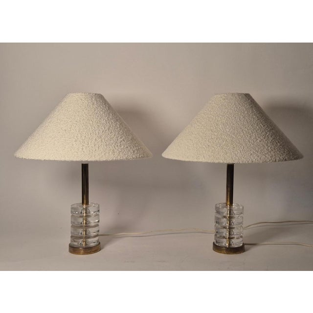 A pair of elegant and timeless classics, tabel lamps with Orrefors glass and brass designed by Carl Fagerlund,...