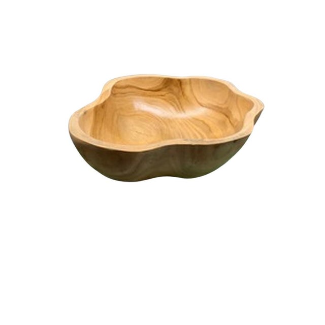 This teak live edge bowl is a unique piece showcasing the natural beauty of teak wood. Crafted by skilled artisans, its...