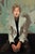 Portrait of Britt Daniel by Michael Carson | Oil on Panel Portrait of a man in a light jacket sitting. For Sale