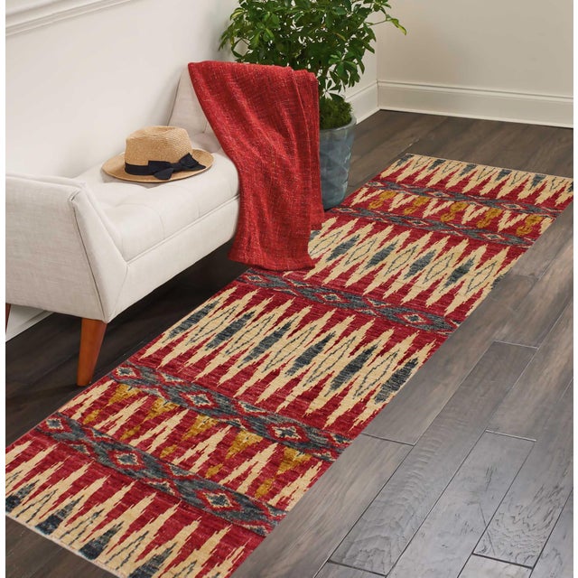 Add a splash of color with this dazzling transitional runner, hand knotted in an all over artful intricate pattern and a...