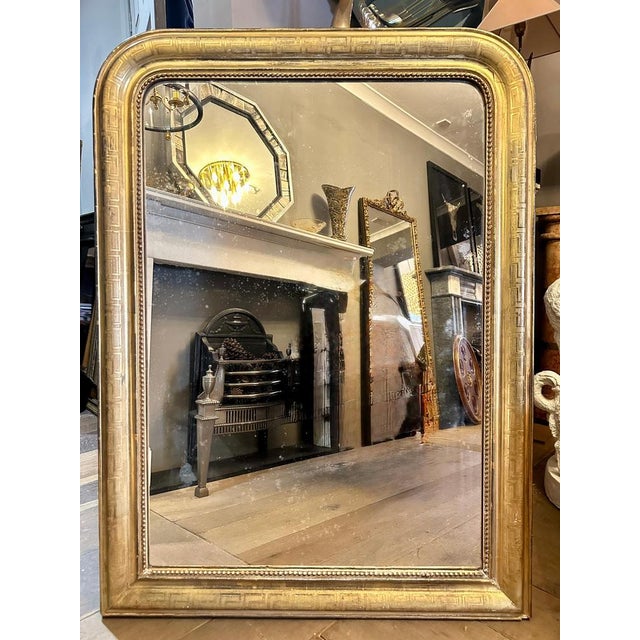 A dome toped Louis Philippe gold gilt mirror, with Greek key motif on the frame with inner beaded slip and original mirror...